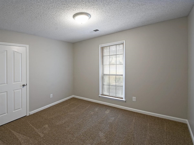 unfurnished room featuring carpet flooring, baseboards, and a textured ceiling