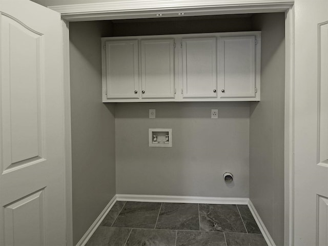 washroom featuring baseboards, washer hookup, cabinet space, dark marble finish flooring, and electric dryer hookup
