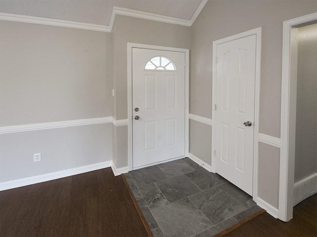 entryway featuring baseboards and ornamental molding