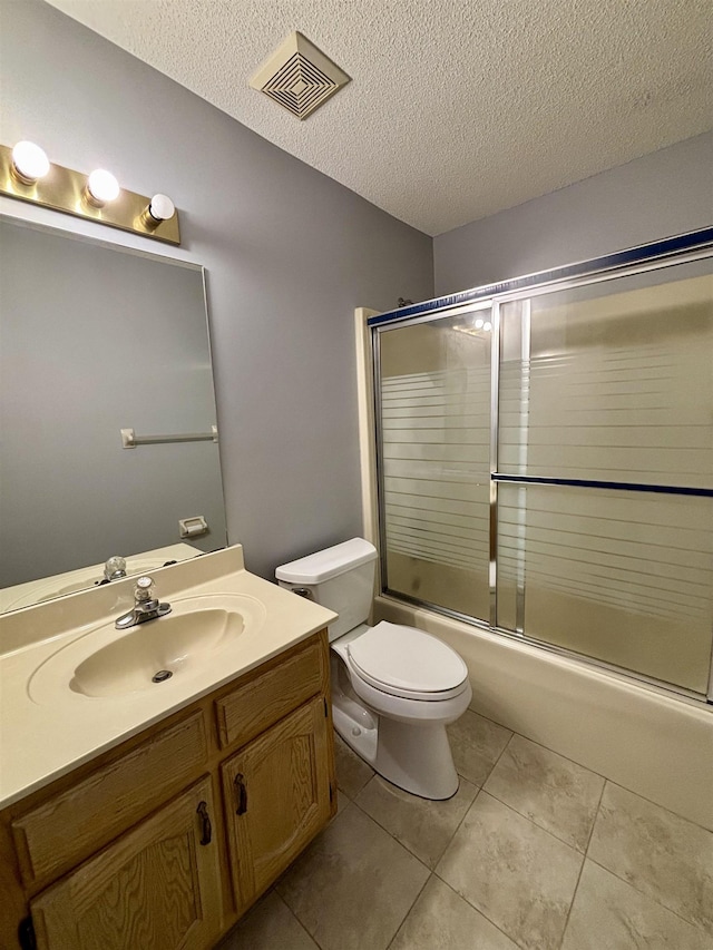 bathroom featuring a textured ceiling, toilet, tile patterned floors, vanity, and enclosed tub / shower combo