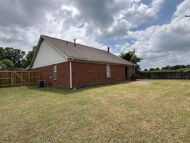 view of home's exterior with brick siding, a patio, a gate, central air condition unit, and roof with shingles