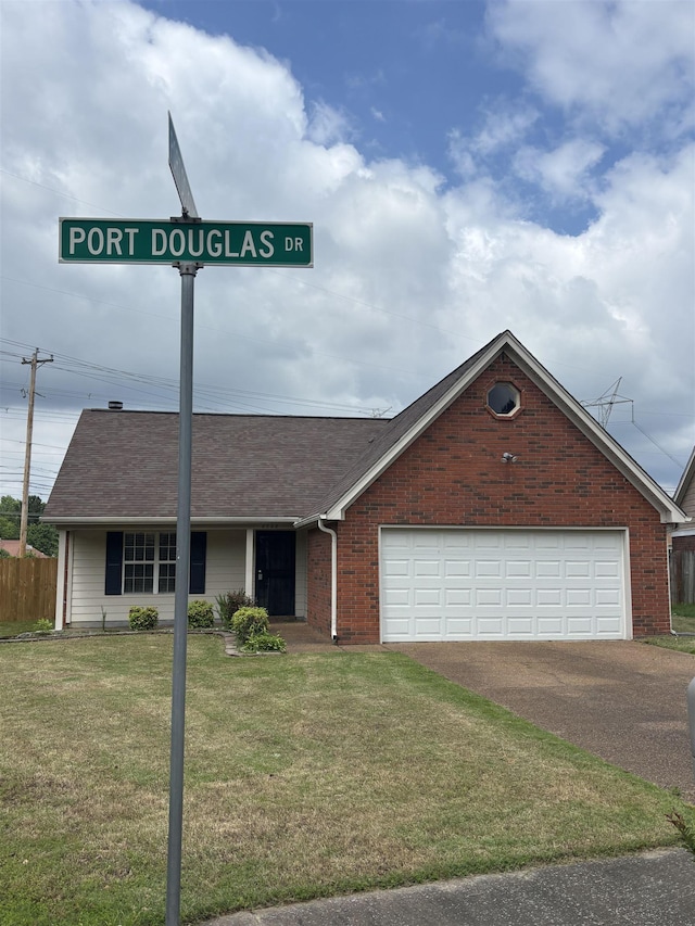 view of front of house with concrete driveway, brick siding, and a shingled roof