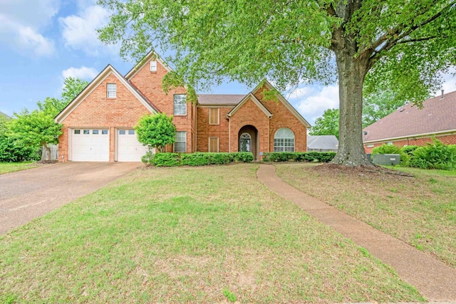 3936 Altruria Rd, Bartlett, TN 38135 - traditional home featuring brick siding, a front yard, driveway, and a garage