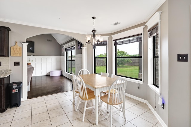 13525 Lapstone Loop, Olive Branch, MS 38654 - dining space with arched walkways, light tile patterned floors, a chandelier, crown molding, and plenty of natural light