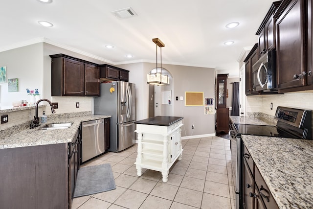 13525 Lapstone Loop, Olive Branch, MS 38654 - kitchen featuring stainless steel appliances, a sink, dark brown cabinets, backsplash, and crown molding
