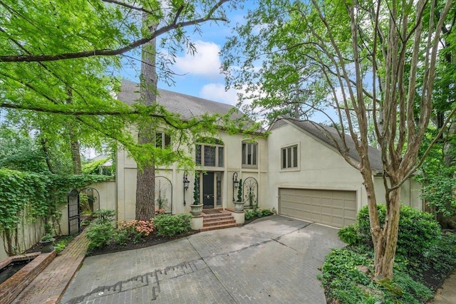 4359 W Cherry Place Dr, Memphis, TN 38117 - view of front of home with stucco siding, driveway, and a garage