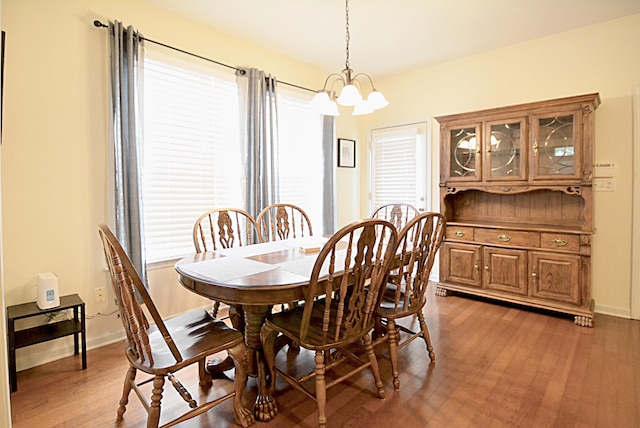 1342 Harbor Park Dr, Memphis, TN 38103 - dining space with a chandelier, healthy amount of natural light, wood finished floors, and baseboards