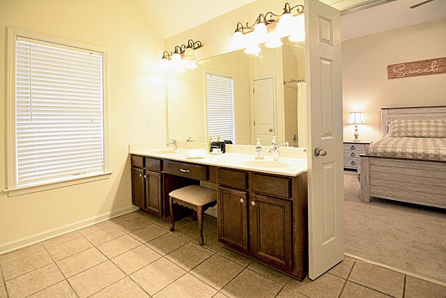 1342 Harbor Park Dr, Memphis, TN 38103 - bathroom with tile patterned flooring, ensuite bath, double vanity, lofted ceiling, and baseboards