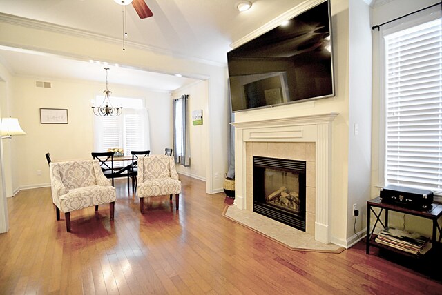 1342 Harbor Park Dr, Memphis, TN 38103 - living room featuring hardwood / wood-style flooring, ceiling fan, healthy amount of natural light, ornamental molding, and a fireplace