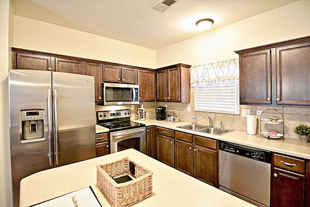 1342 Harbor Park Dr, Memphis, TN 38103 - kitchen featuring stainless steel appliances, a sink, light countertops, and decorative backsplash