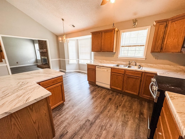 kitchen with dishwasher, a sink, brown cabinetry, dark wood-style flooring, and vaulted ceiling