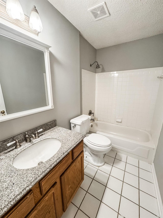 bathroom with tile patterned floors, washtub / shower combination, toilet, vanity, and a textured ceiling