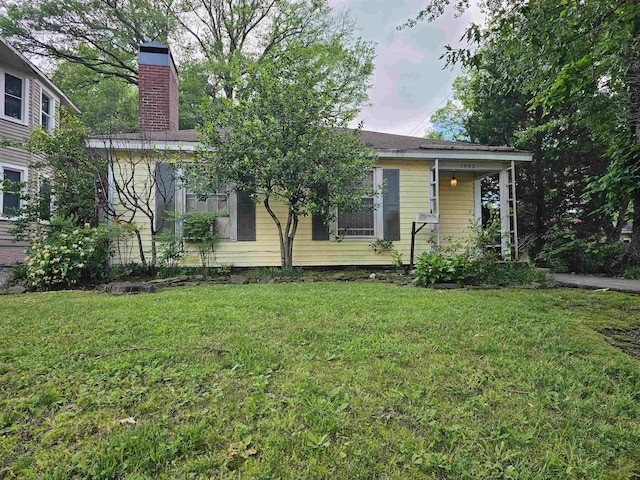 1993 Higbee Ave, Memphis, TN 38104 - view of front facade with a front yard and a chimney