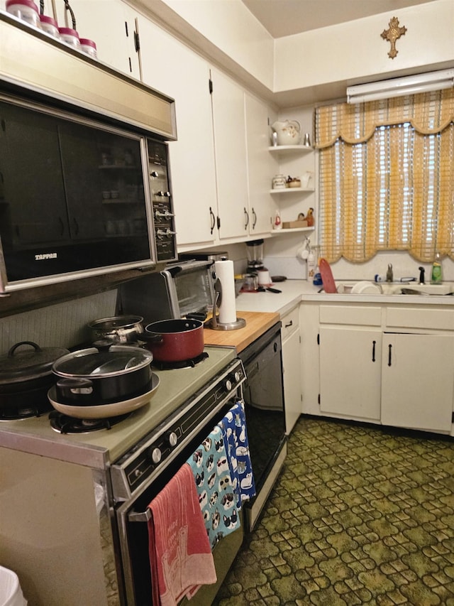 1993 Higbee Ave, Memphis, TN 38104 - kitchen with electric range oven, dishwasher, black microwave, a sink, and white cabinets