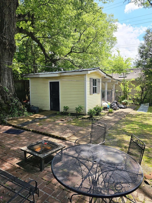 1993 Higbee Ave, Memphis, TN 38104 - view of outbuilding with a fire pit, outdoor dining area, and an outdoor structure