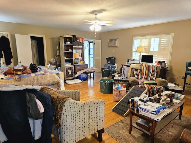 1993 Higbee Ave, Memphis, TN 38104 - living area featuring healthy amount of natural light, a ceiling fan, wood finished floors, and a wall mounted AC
