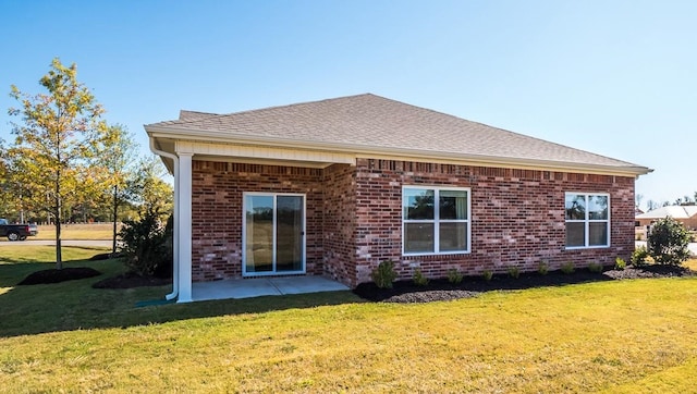 8005 Royster Creek Dr E, Millington, TN 38053 - rear view of house featuring a lawn, brick siding, roof with shingles, and a patio area