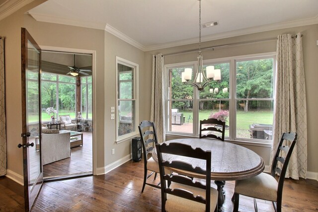 75 Windgrove Cv, Piperton, TN 38017 - dining space featuring dark wood-style floors, a chandelier, baseboards, crown molding, and healthy amount of natural light