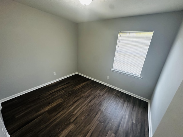 2232 Amethyst Cv, Memphis, TN 38127 - empty room featuring dark wood-style flooring and baseboards