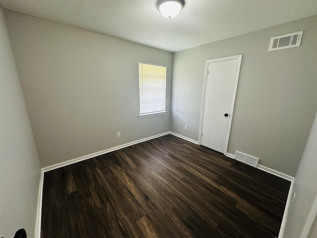 2232 Amethyst Cv, Memphis, TN 38127 - unfurnished room featuring dark wood finished floors, baseboards, and a textured ceiling