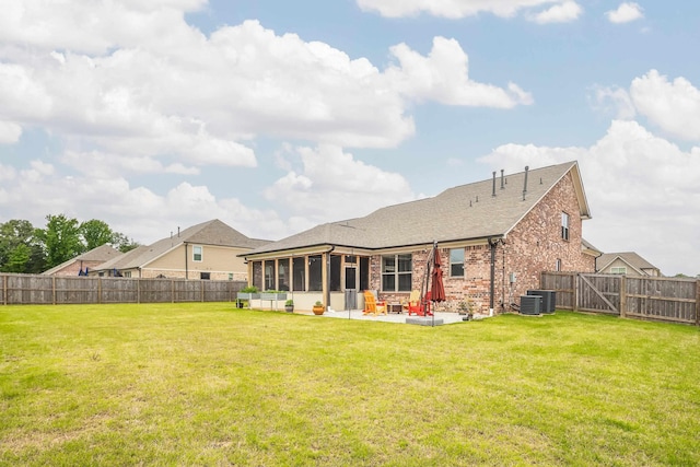 6423 Osier Cv, Bartlett, TN 38135 - back of house featuring a sunroom, a patio area, brick siding, central air condition unit, and a shingled roof