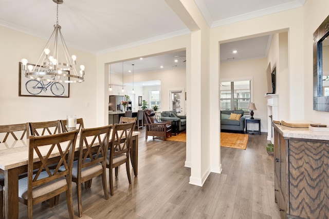 6423 Osier Cv, Bartlett, TN 38135 - dining room with wood finished floors, ornamental molding, a chandelier, and baseboards