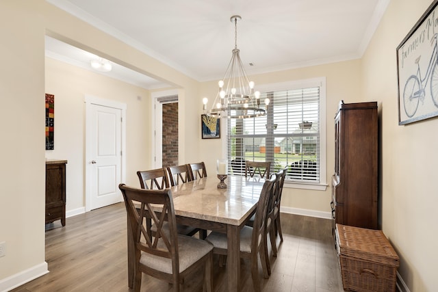 6423 Osier Cv, Bartlett, TN 38135 - dining area with dark wood finished floors, a chandelier, crown molding, and baseboards