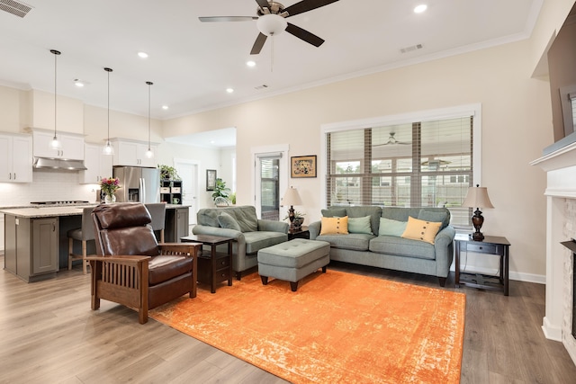 6423 Osier Cv, Bartlett, TN 38135 - living area with a ceiling fan, light wood-type flooring, crown molding, recessed lighting, and a fireplace