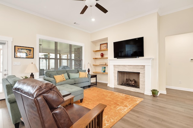 6423 Osier Cv, Bartlett, TN 38135 - living area featuring ceiling fan, ornamental molding, wood finished floors, a stone fireplace, and baseboards