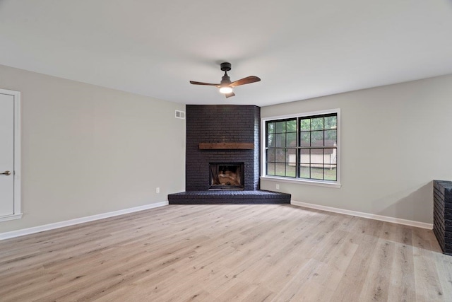 6410 Coteswood Rd, Memphis, TN 38134 - unfurnished living room featuring a brick fireplace, a ceiling fan, wood finished floors, and baseboards