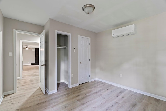 6410 Coteswood Rd, Memphis, TN 38134 - unfurnished bedroom with a wall unit AC, light wood-style flooring, baseboards, and a closet