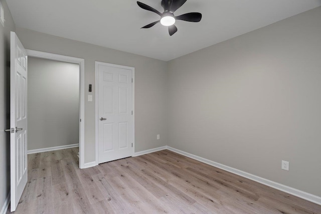 6410 Coteswood Rd, Memphis, TN 38134 - unfurnished bedroom featuring light wood finished floors, baseboards, and a ceiling fan