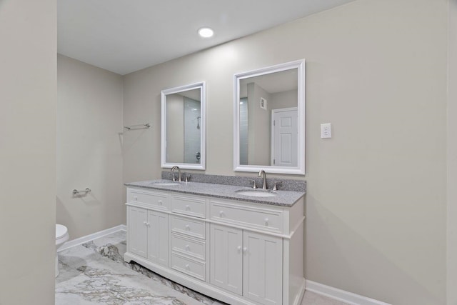 6410 Coteswood Rd, Memphis, TN 38134 - bathroom featuring baseboards, toilet, and double vanity