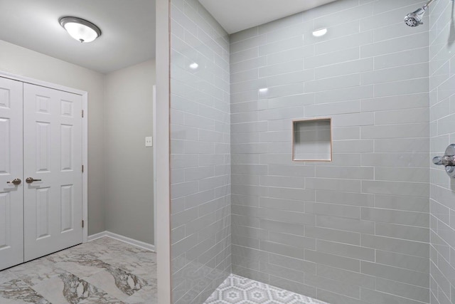 6410 Coteswood Rd, Memphis, TN 38134 - bathroom with tiled shower and marble look tile flooring