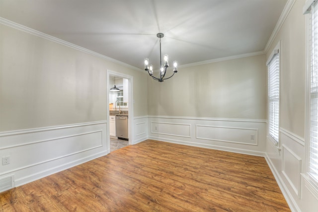 7238 Mcvay Rd, Germantown, TN 38138 - spare room with a chandelier, crown molding, wood finished floors, a decorative wall, and wainscoting