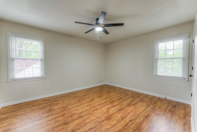 7238 Mcvay Rd, Germantown, TN 38138 - unfurnished room with light wood-style floors, ceiling fan, healthy amount of natural light, baseboards, and a textured ceiling