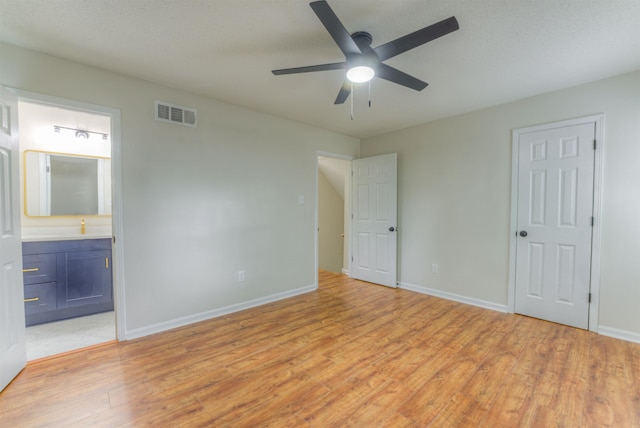 7238 Mcvay Rd, Germantown, TN 38138 - unfurnished bedroom featuring light wood-style flooring, baseboards, ensuite bathroom, and ceiling fan