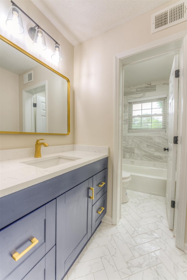 7238 Mcvay Rd, Germantown, TN 38138 - bathroom featuring toilet, marble finish floors, vanity, a tub, and a textured ceiling