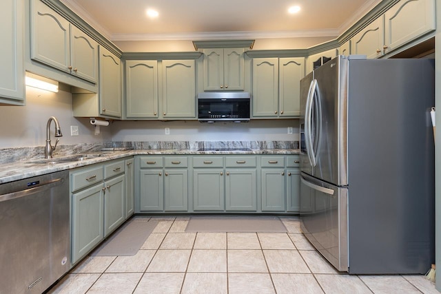 1796 Campden Dr, Collierville, TN 38017 - kitchen featuring appliances with stainless steel finishes, green cabinetry, ornamental molding, light tile patterned flooring, and a sink