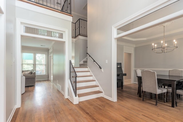 1796 Campden Dr, Collierville, TN 38017 - stairs with a chandelier, wood finished floors, crown molding, and baseboards