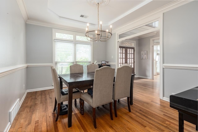 1796 Campden Dr, Collierville, TN 38017 - dining area with a chandelier, wood finished floors, plenty of natural light, a tray ceiling, and ornamental molding