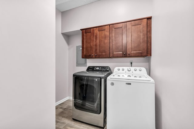 858 Gunnison Dr, Collierville, TN 38017 - laundry area with washing machine and dryer, cabinet space, light wood-style floors, electric panel, and baseboards