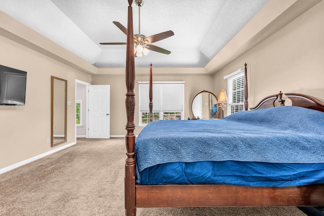 858 Gunnison Dr, Collierville, TN 38017 - carpeted bedroom featuring a raised ceiling, baseboards, a textured ceiling, and a ceiling fan