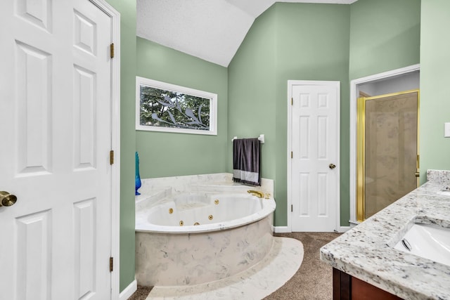 858 Gunnison Dr, Collierville, TN 38017 - bathroom with baseboards, a jetted tub, a stall shower, double vanity, and vaulted ceiling