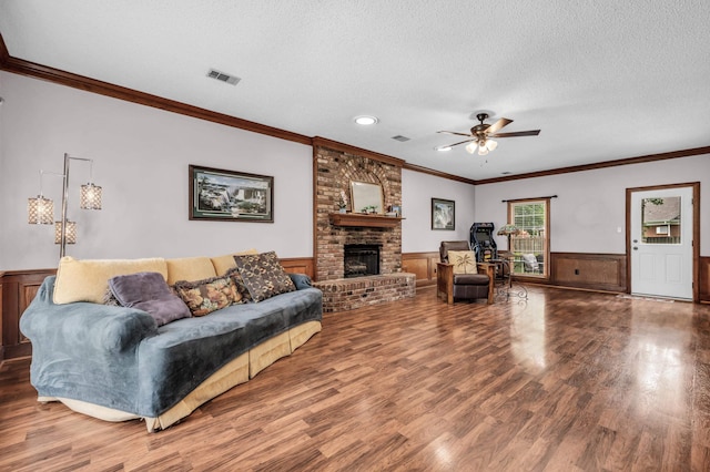 858 Gunnison Dr, Collierville, TN 38017 - living area with a ceiling fan, a textured ceiling, wood finished floors, wainscoting, and a fireplace