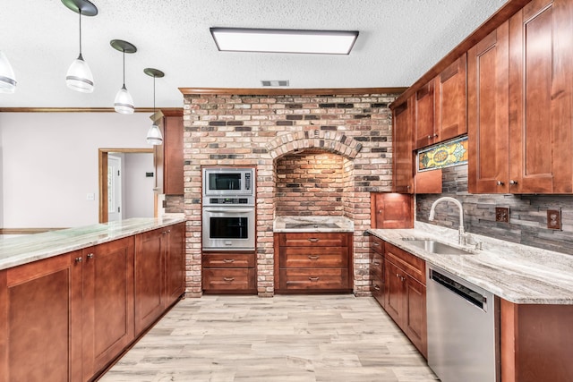 858 Gunnison Dr, Collierville, TN 38017 - kitchen with appliances with stainless steel finishes, a sink, light stone counters, a textured ceiling, and backsplash