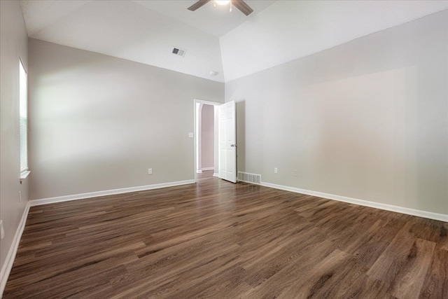 empty room with ceiling fan, dark wood-style floors, baseboards, and high vaulted ceiling