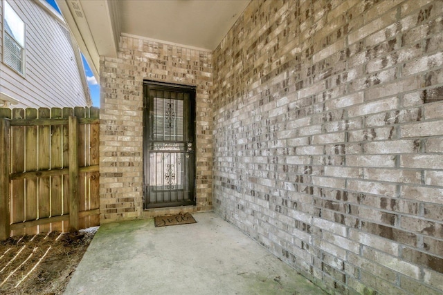 entrance to property with brick siding