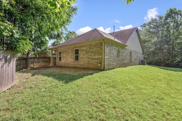 view of side of home featuring brick siding, central air condition unit, and a shingled roof