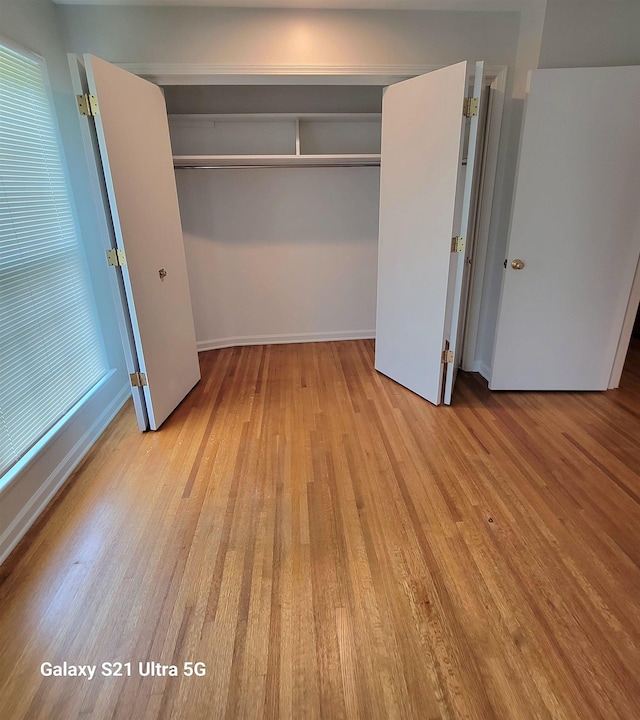 5551 Derron Dr, Memphis, TN 38115 - unfurnished bedroom with a closet, wood finished floors, and baseboards